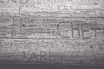 names carved into wood 