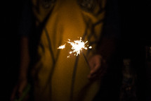boy holding a sparkler 