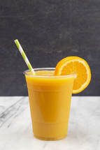 Freshly Squeezed Orange Juice in a Plastic Disposable Cup