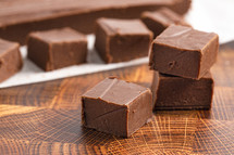 Chocolate fudge squares on a wood table