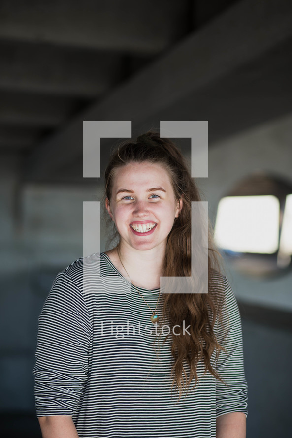 smiling young woman in a parking garage 