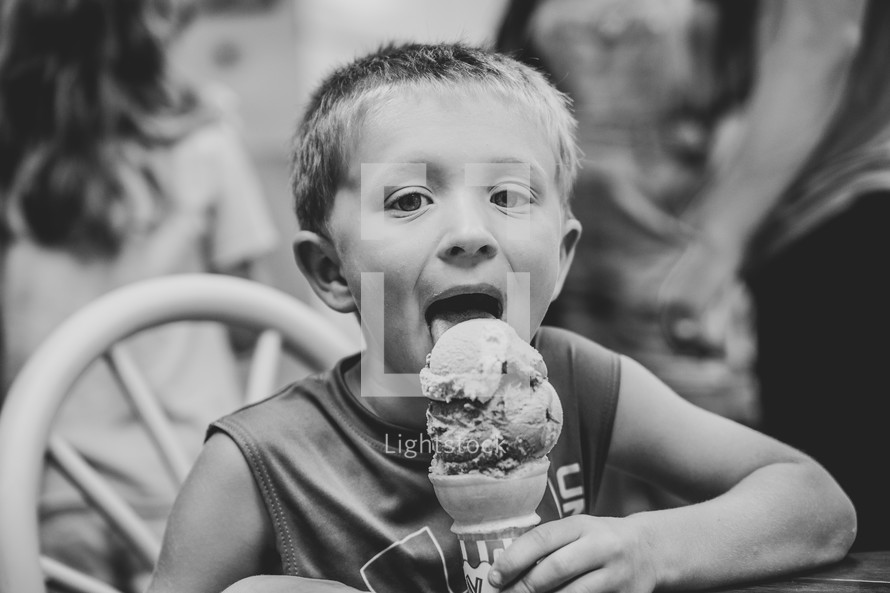 a boy eating an ice cream cone 