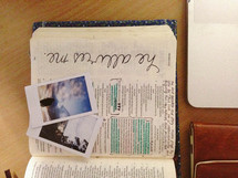 polaroid pictures on the pages of a Bible 