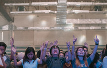 group with hands raised at worship service 