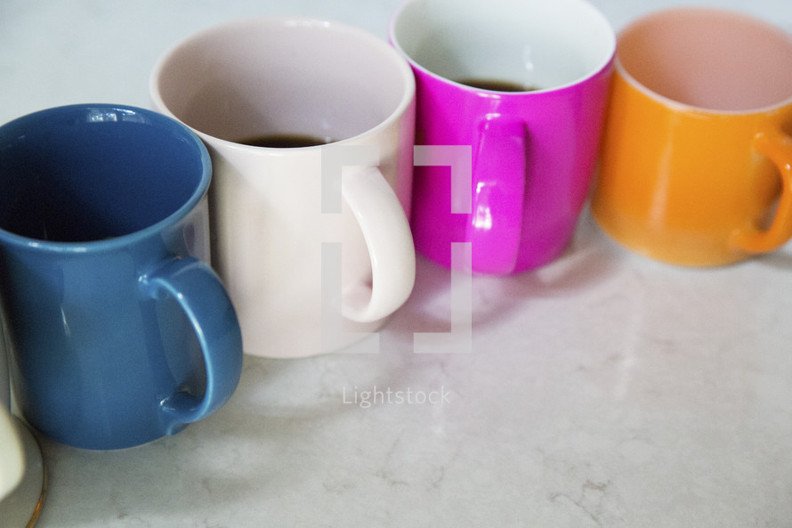 row of colorful coffee mugs 