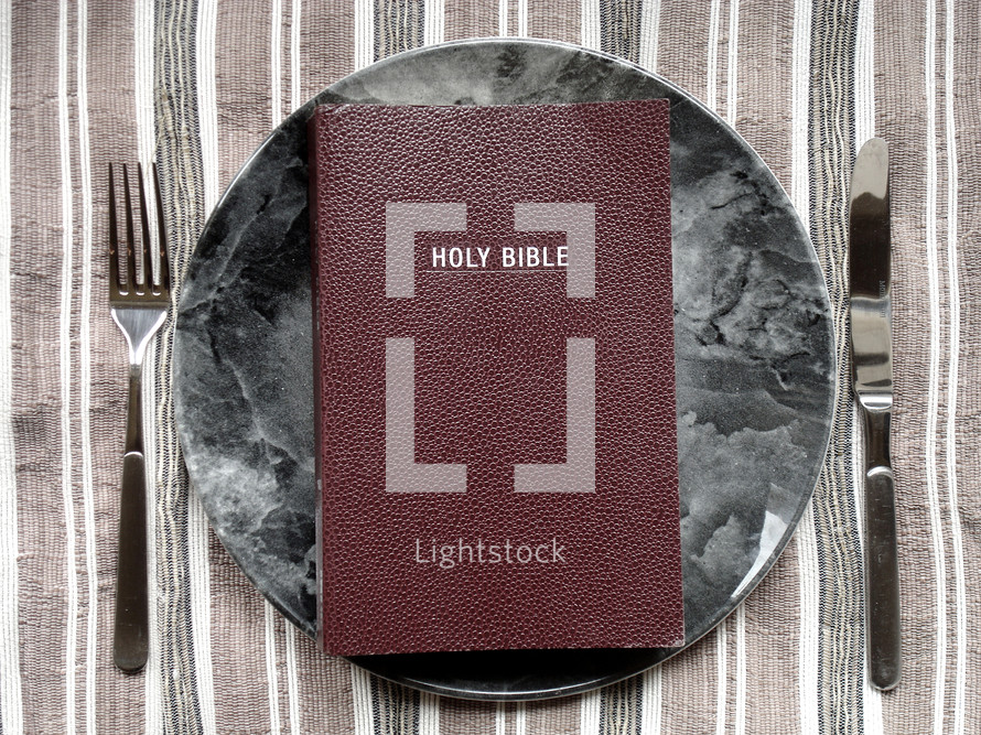 Holy Bible on a dinner plate.
