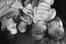 a family hugging on the floor 
