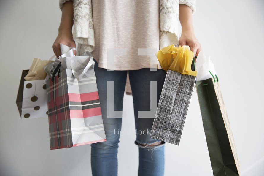 woman holding holiday gift bags 