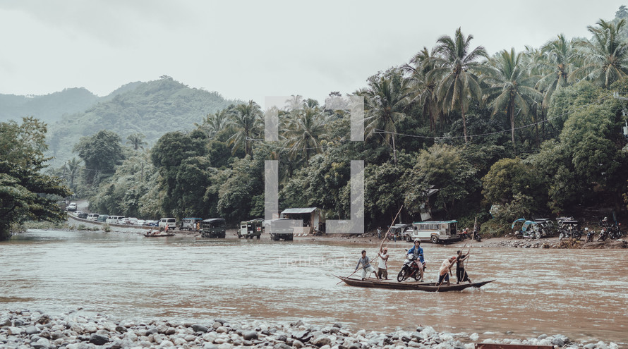 paddling a make-shift raft across a river 