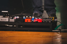 guitar pedals on stage 