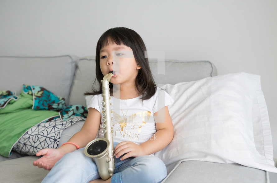 a child playing with a toy saxophone 
