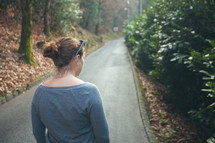 woman standing on the middle of a path 