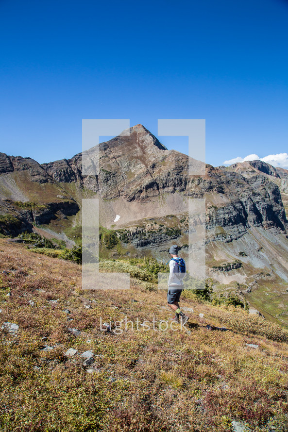 a man hiking up a mountainside 