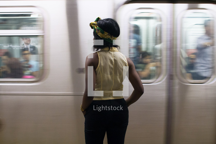 a woman waiting for a subway train 