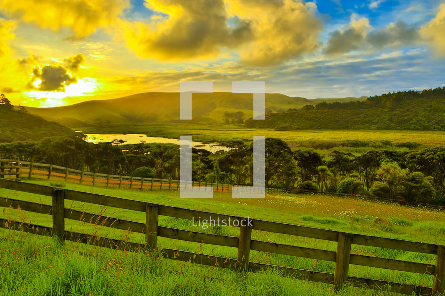 sunrise over a green pasture 