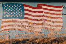 American flag painted on a rural gas station building 
