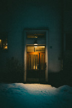 snow outdoors in front of a door 