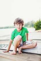 a boy child on an overturned boat 