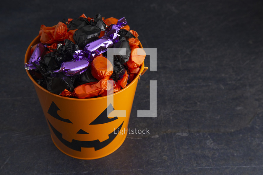 candy in trick-or-treat buckets 