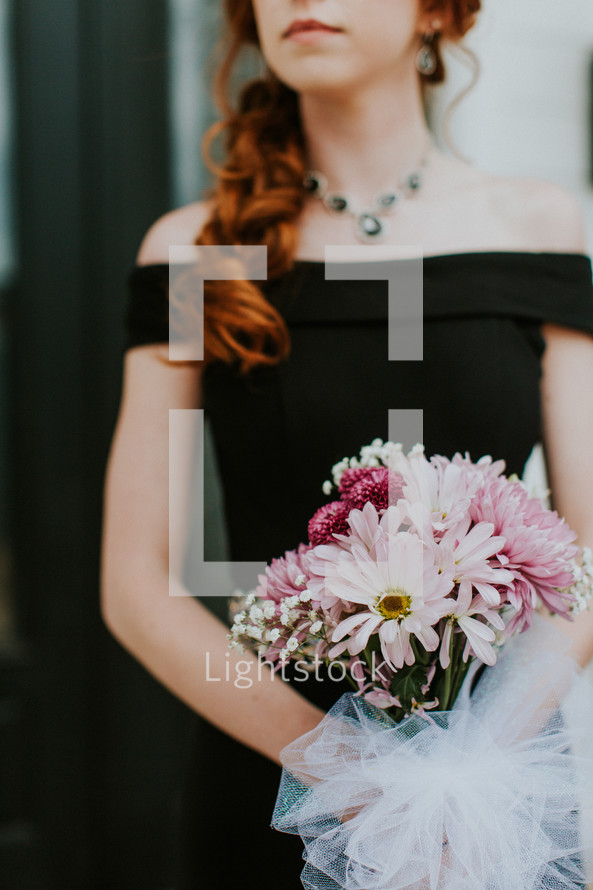 teen girl holding a bouquet for prom