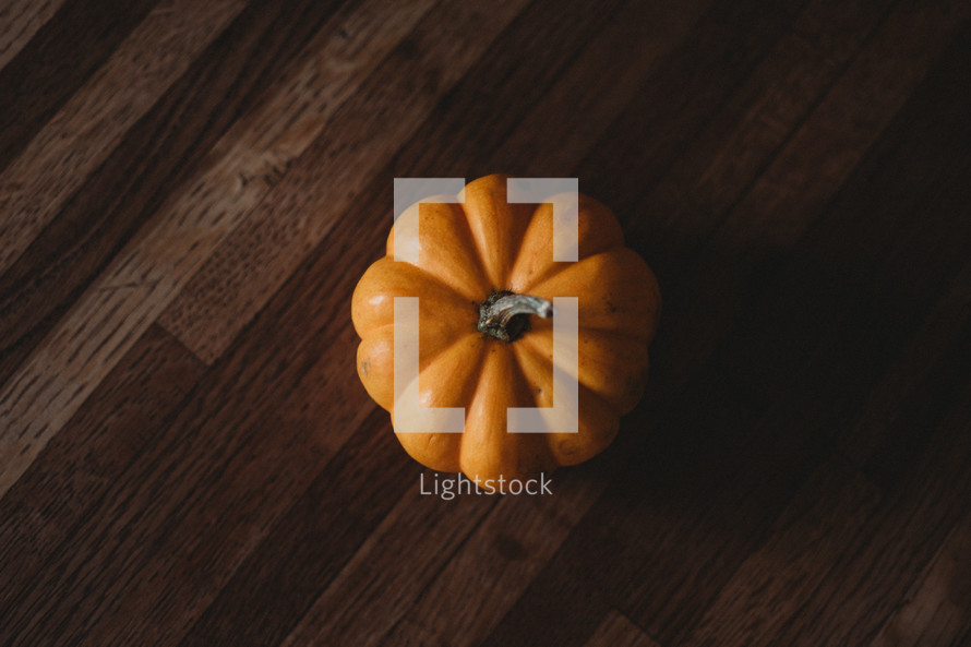 orange pumpkin on a wood table 