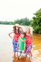 siblings standing in lake water 