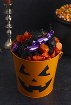 candy in trick-or-treat buckets 