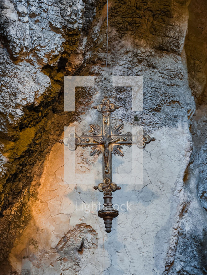 Crucifix hanging inside a Cave