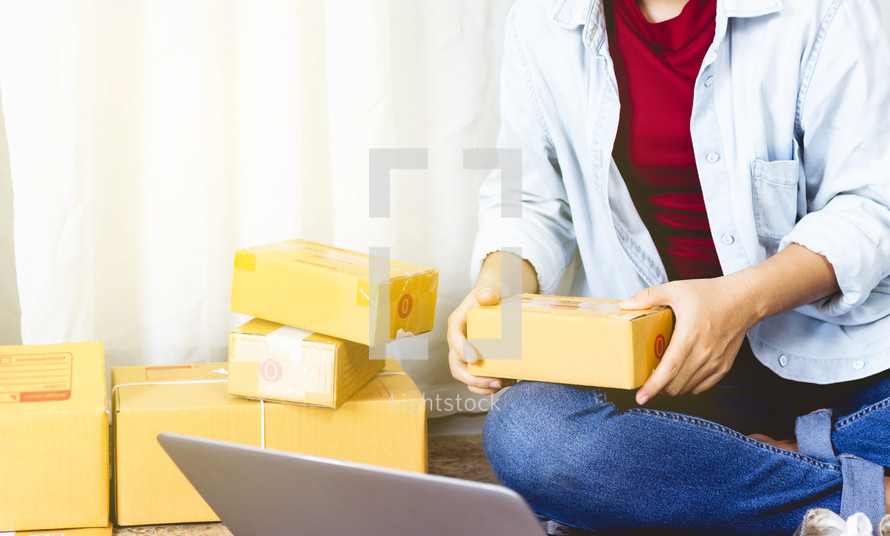 a woman mailing packages from home 