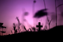 silhouette of a cross against a purple sky 