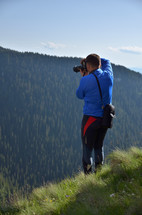 photographer on a mountaintop 