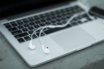 earbuds on a laptop computer 