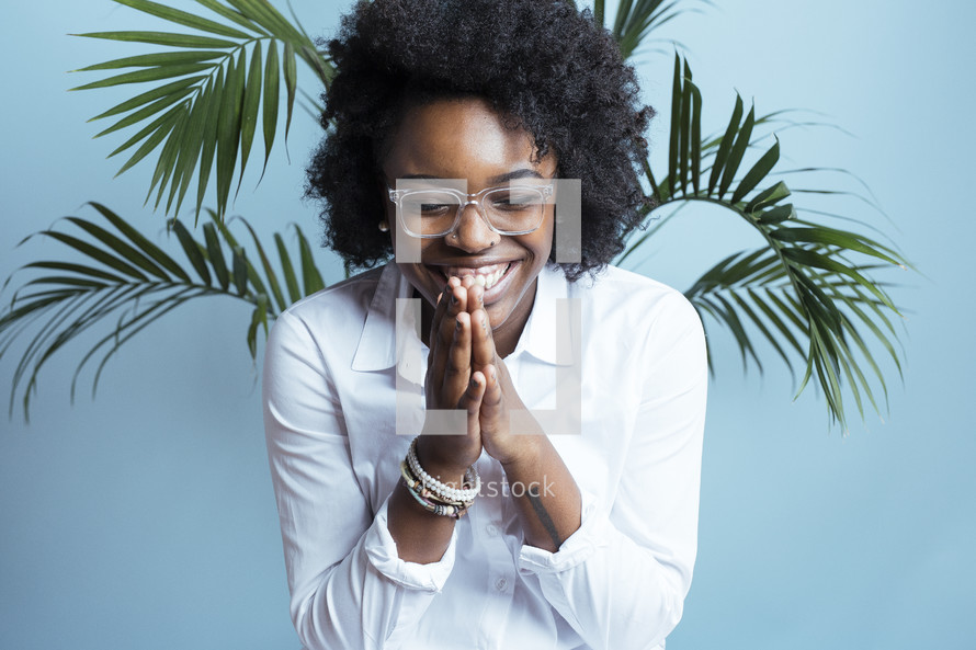 young African American female model with hands in prayer