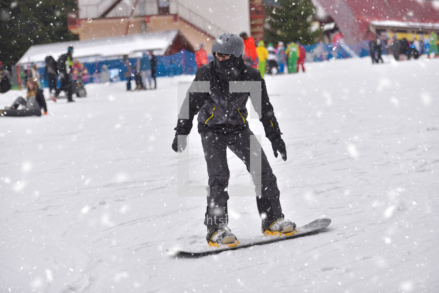 snowboarding on a busy ski slope 