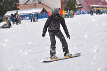snowboarding on a busy ski slope 