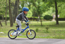Active child riding a bike at a park 