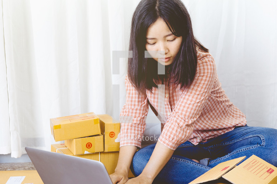 a woman mailing packages from home 