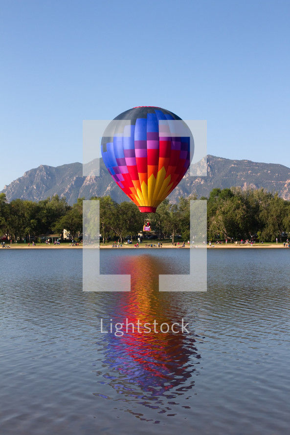 Colorful Hot Air Balloon flying over a Colorado lake