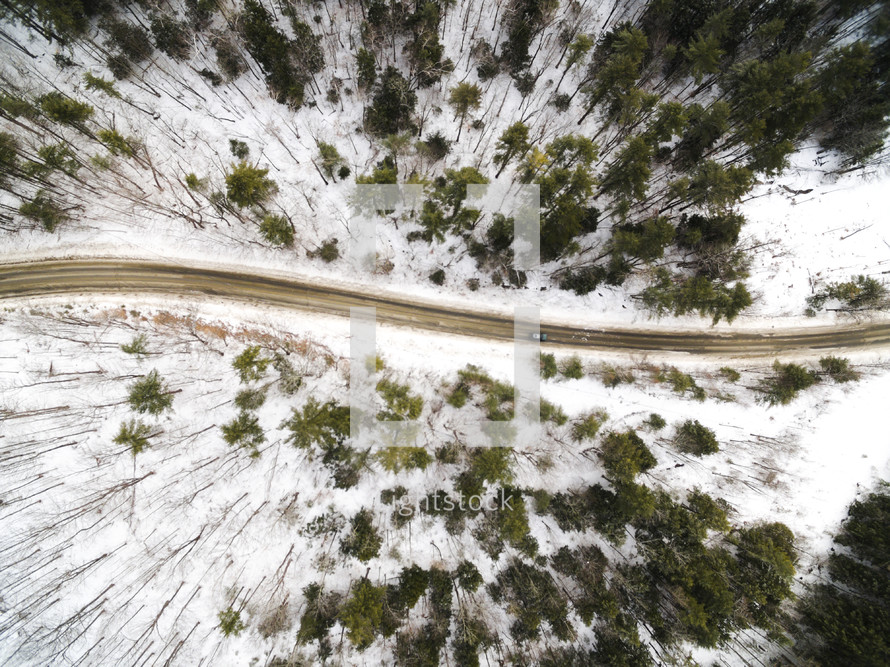 aerial view over a road in the snow 