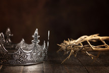 crown of thorns and crown on a wooden background 