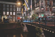 Amsterdam canal, bridge, and medieval houses in the evening