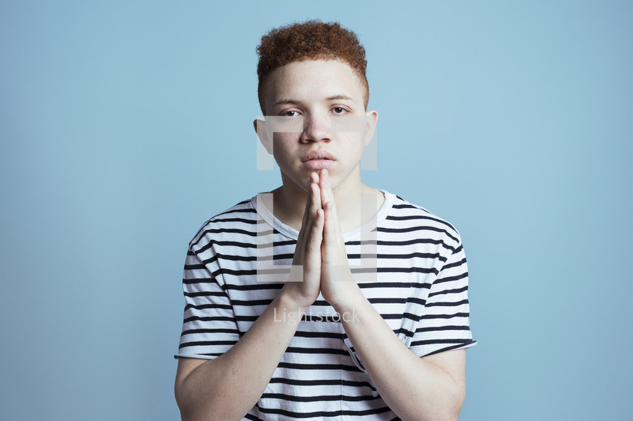 young African American male model with praying hands 