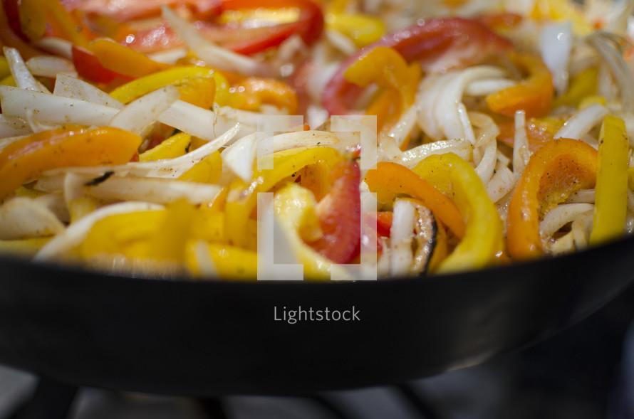 peppers and onions on a skillet 
