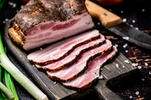 Pork lard cut on a cutting board. Against a dark background. High quality photo