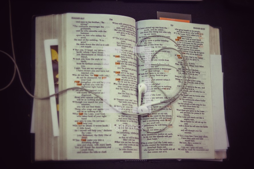 earbuds on the pages of a Bible 