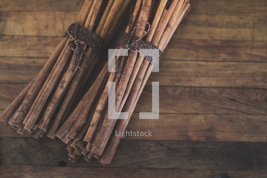 Groups of cinnamon sticks on wood