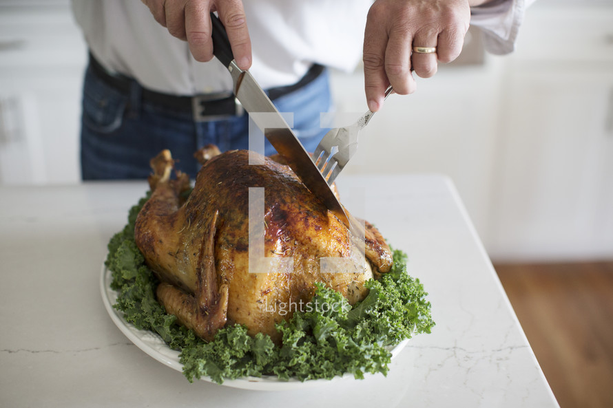 a man carving a turkey 