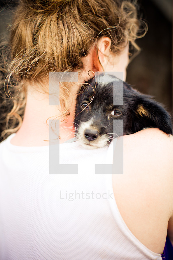 Dog on a woman's shoulder.