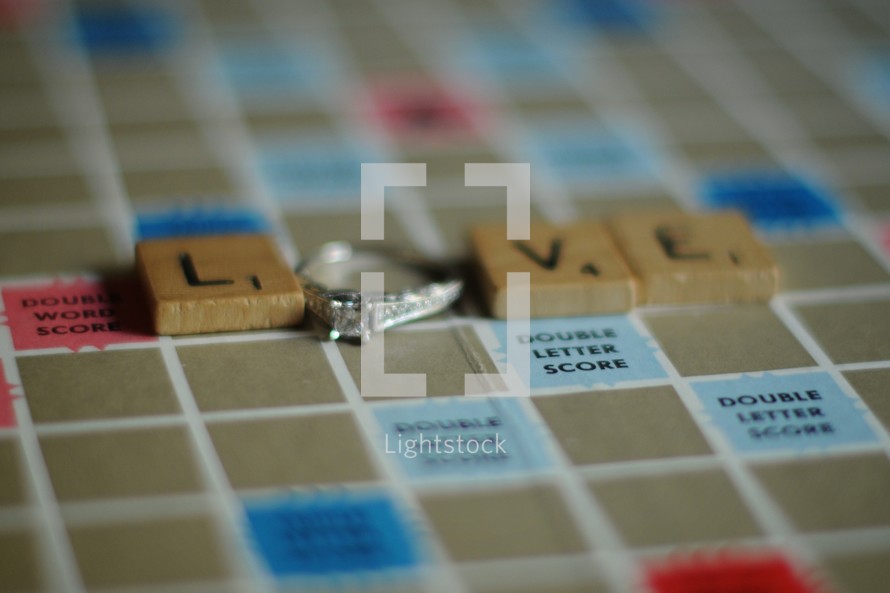 word love out of scrabble pieces and engagement ring 