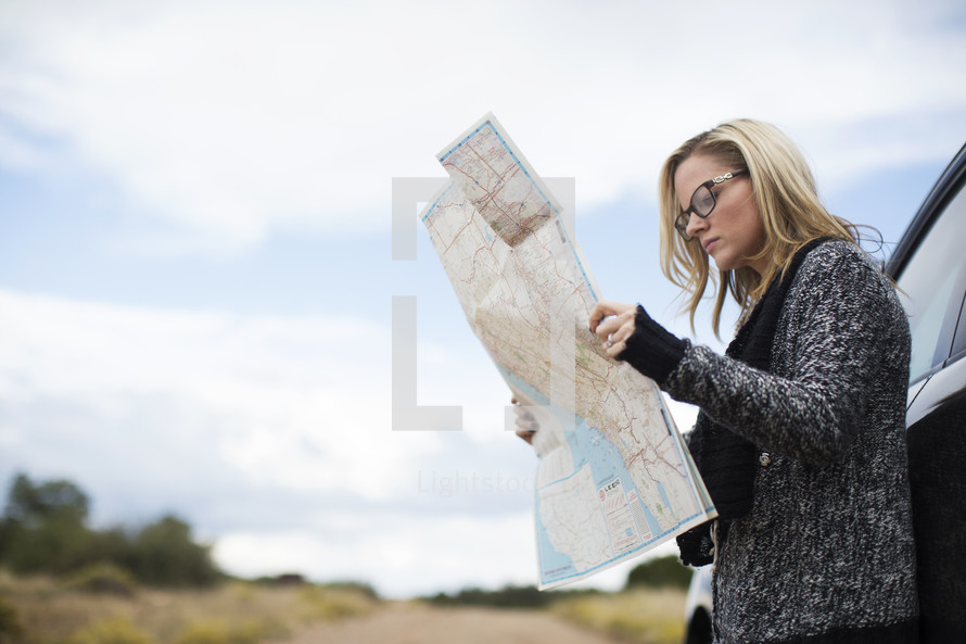 a woman looking at a road map 